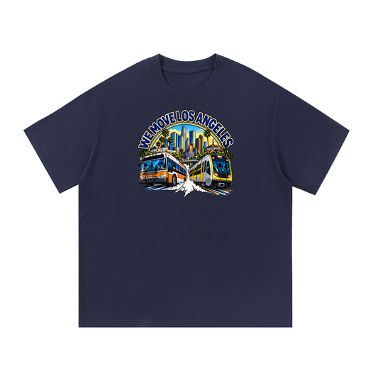 We Move Los Angeles Tee — navy heavyweight cotton with the LA transit badge featuring the LA skyline, Metro train, and bus, printed on the front.